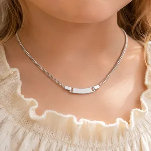 Stainless steel curb chain necklace detail showing blank curved ID plate for custom engraving.