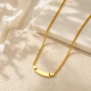 Close-up detail of a gold stainless steel curb chain necklace with a blank curved plate.
