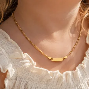 Gold tone curb chain necklace featuring a curved blank ID plate pendant for women detail view.