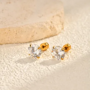 Detail shot of sparkling round zircon stud earrings with gold stainless steel setting on stone.
