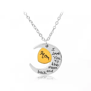 Silver crescent moon necklace with gold heart pendant engraved with Mom and love message.