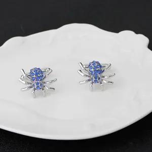 Boutons de manchette araignée argentés avec strass bleus pour chemise homme d'affaires.