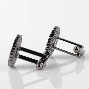 Stylish black gunmetal gear textured round French cufflinks for men's shirt details.