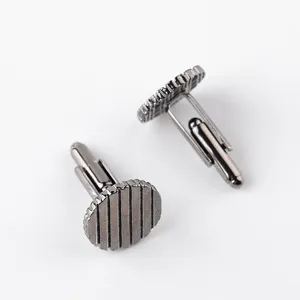 Detailed close-up view of dark metal cufflinks featuring a textured striped round face.