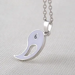 Detailed shot of a stylish silver-tone yin yang pendant necklace, perfect for friends and couples.