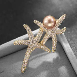 Detailed shot of elegant double starfish pearl brooch with sparkling rhinestones.