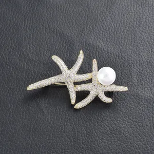 Double starfish pearl brooch detail shot, sparkling zircon crystals and elegant white pearl design.
