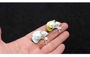 Exquisite ginkgo leaf pearl brooch with sparkling zircon, elegant retro clothing accessory.
