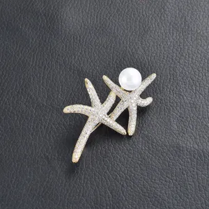 Exquisite starfish pearl brooch featuring sparkling zircon inlay on elegant gold tone metal.