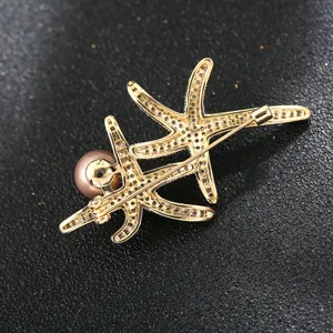 Close-up view of a delicate double starfish pearl brooch with sparkling pave zirconia details.