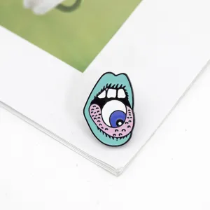 Detail view of quirky punk enamel brooch featuring an eyeball mouth design, creative fashion jewelry.