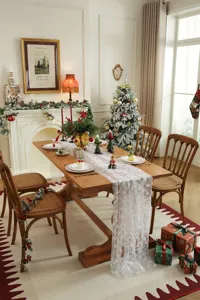 White lace Christmas table runner with silver foil tree print, elegant holiday dining decor.