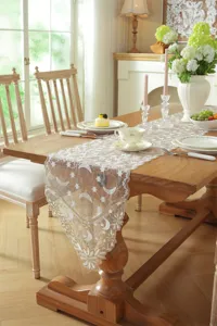 Detailed view of the elegant white and gold lace table runner featuring charming star and moon embroidery.