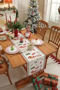 Runner da tavola natalizio in jacquard con testo festivo e nappe per decorare la sala.