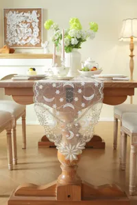 Exquisite white and gold lace table runner featuring star and moon embroidery details.