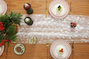 White mesh lace table runner with silver printed Christmas trees for dining table decor.