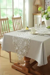 Elegant lace table runner detail featuring stars and moons in a cozy dining room setting.