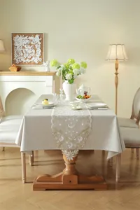 Elegant beige lace table runner with gold star and moon embroidery, perfect for dining room decor.