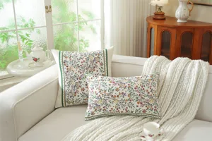 Botanical jacquard throw pillow covers with vintage floral and bird patterns on a cozy sofa.