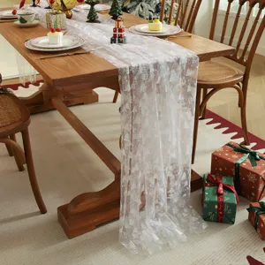 White mesh table runner with silver Christmas tree print for holiday dining room decor.