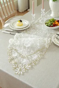 Exquisite white and gold lace table runner featuring delicate star and moon embroidery.