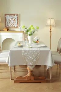 Detailed view of elegant white and gold star moon lace table runner, perfect dining table decor.