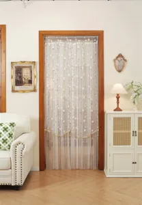 Detailed view of the French style floral lace door curtain displayed in a cozy room setting.