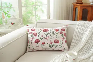 Detail view of the woven floral throw pillow featuring beautiful red carnations on sofa.