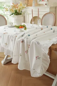 Elegant white floral embroidered tablecloth with ruffled edge for dining room table decor