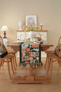 Detailed shot of Easter table runner featuring woven rabbit and carrot jacquard patterns with tassels.