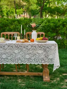 Elegant white lace tablecloth with French floral pattern for outdoor wedding and dining table decor.
