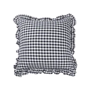 Detail shot of the black and white gingham checkered throw pillow with delicate ruffled edge.