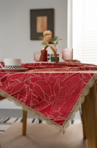 Red gold leaf pattern tablecloth with elegant lace trim for festive dining room decor.