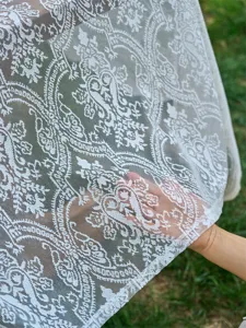 White French lace tablecloth detail shot, elegant floral pattern for wedding party decor.