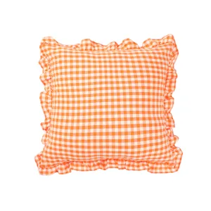 Orange and white checkered throw pillow detail, featuring cute ruffles and soft cotton fabric.