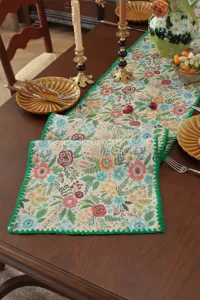 Vintage American retro floral table runner and placemat set with green crocheted shell edge.