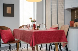 Red jacquard tablecloth with gold lace trim, festive holiday dining table cover decor.