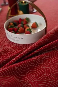 Festive red gold jacquard tablecloth detail shot, premium velvet dining table cover for new year party.