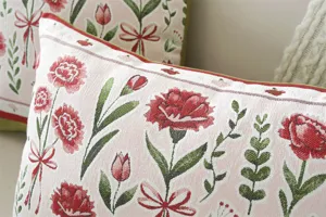 Close-up detail of vintage floral jacquard cushion cover with elegant red ribbon patterns.