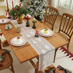 Camino de mesa navideño de encaje blanco francés con motivos de copos y campanas