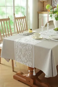 White lace embroidered table runner with tassels, modern minimalist dining table decor.