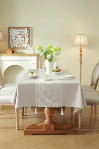 Elegant lace embroidered table runner with delicate floral pattern and fringe tassels for dining table decor.