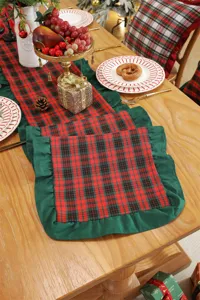 Christmas plaid table runner detail shot, red and green check with green ruffle edge decor.
