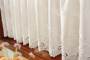 French white embroidered hollow lace short curtain detail, vintage style kitchen window partition.