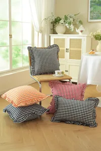 Detailed view of French pastoral ruffled gingham throw pillows for cozy home decoration.