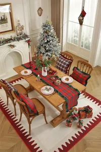 Christmas plaid table runner and pillow covers with green ruffled edge in festive dining room.