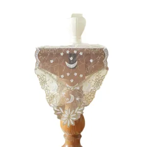 White and gold lace table runner featuring embroidered stars, moon, and floral wave patterns.