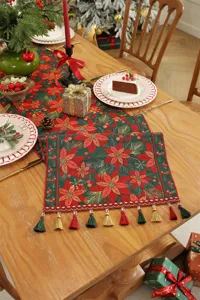 Runner da tavola natalizio in jacquard con motivo di stella di Natale e nappe festive.