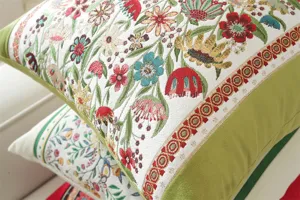 Close-up detail of retro floral jacquard throw pillow cover with green velvet border.