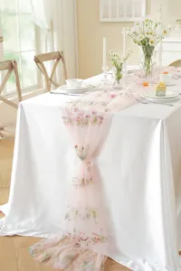 Pink lace table runner with colorful floral embroidery and vintage design for wedding decor.